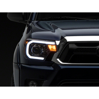 Raxiom 12-15 Toyota Tacoma Axial Projector Headlights w/ SEQL LED Bar- Blk Housing (Clear Lens)